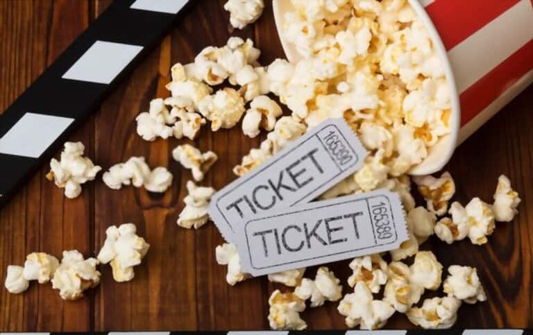 movie tickets and popcorn on the wooden table