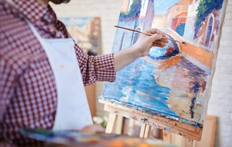 a man paints Italian landscape