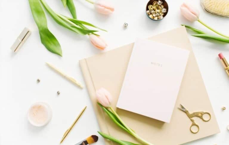 notebook on bright color concept with flowers and scissors and brushes notebook on bright color concept with flowers and scissors and brushes