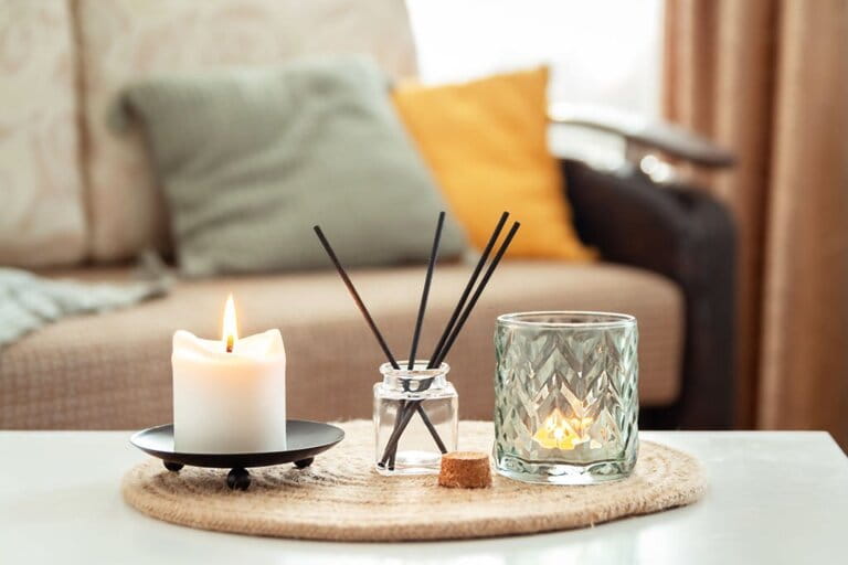Scented candles and fragrance on the table in the living room. Aromatherapy, home aromatherapy. Concept of home relaxation and anti-stress.