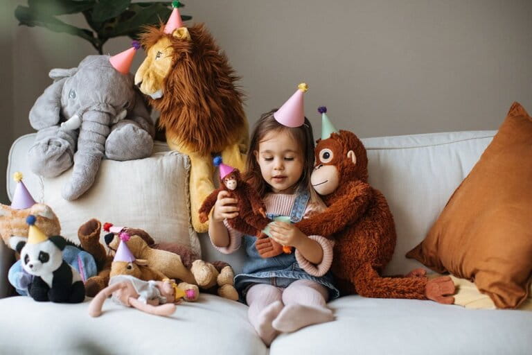 little girl sitting next to many favorite teddy bears little girl sitting next to many favorite teddy bears