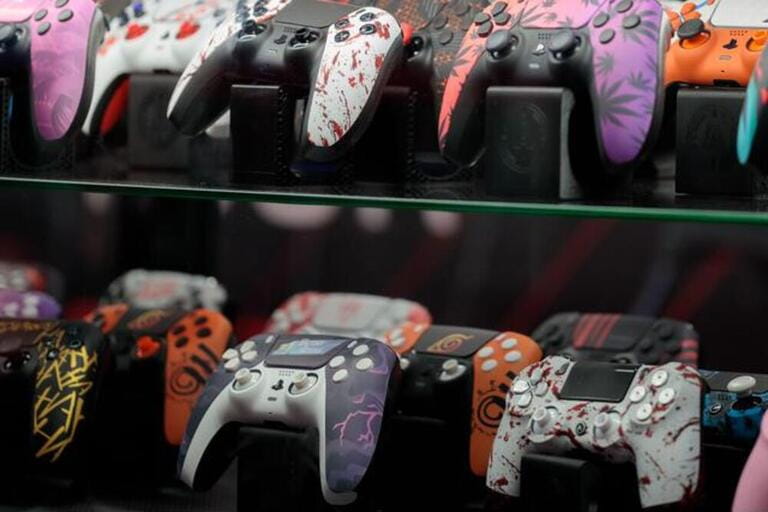 Store showcase with gamepads, video game accessories. Poznan Game Arena, a video game trade show.