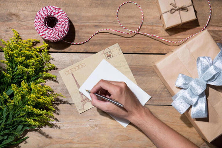Christmas decorated gift box over wooden background.