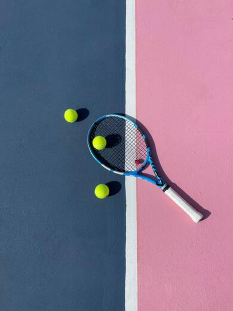 Tennis Racquet and Tennis Balls on Tennis Court
