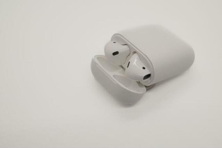 wireless earbuds in a case on a white background