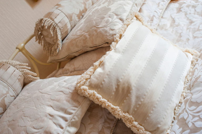 Cushions and pillows arranged on a bed. Cushions and pillows arranged on a bed.