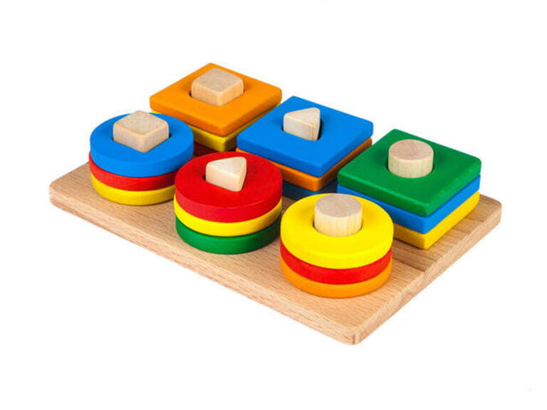 Photo of a wooden toy children's sorter with small wooden details in the form of geometric shapes (rectangle, square, circle, triangle), in different Photo of a wooden toy children's sorter with small wooden details in the form of geometric shapes (rectangle, square, circle, triangle), in different