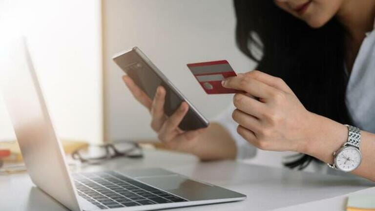 Shopping online with smartphone and credit card on hand