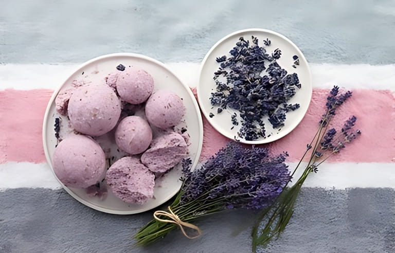 Handmade lavender bath bombs and lavender flowers on striped bath towel Handmade lavender bath bombs and lavender flowers on striped bath towel