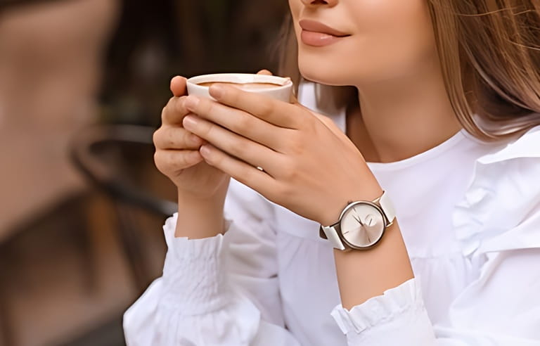 Woman with stylish wrist watch drinking coffee in cafe Woman with stylish wrist watch drinking coffee in cafe